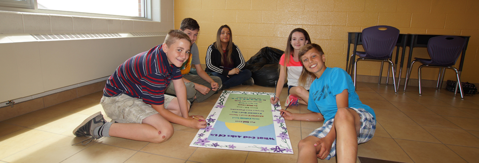 students in a hallway painting